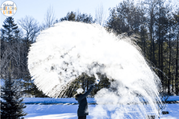 mpemba experiment shows a person throwing hot water around them and it turning into snow.