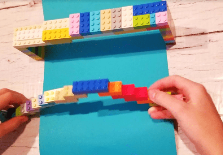 bridge building shows a child making a bridge from colorful lego.