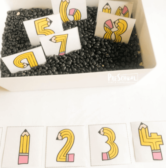 stem challenge shows a bin of black beans with printed numbers in it that look like pencils.