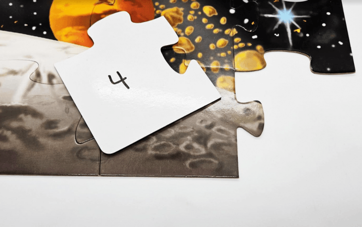 build your own escape room shows the back of a puzzle piece with the number 4 on it.