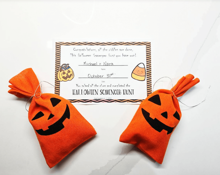 halloween game for kids shows a completion certificate for a scavenger hunt and two bags with pumpkins on them.