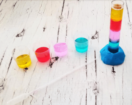 chemistry for kids shows cups with different liquids and a test tube with layers.