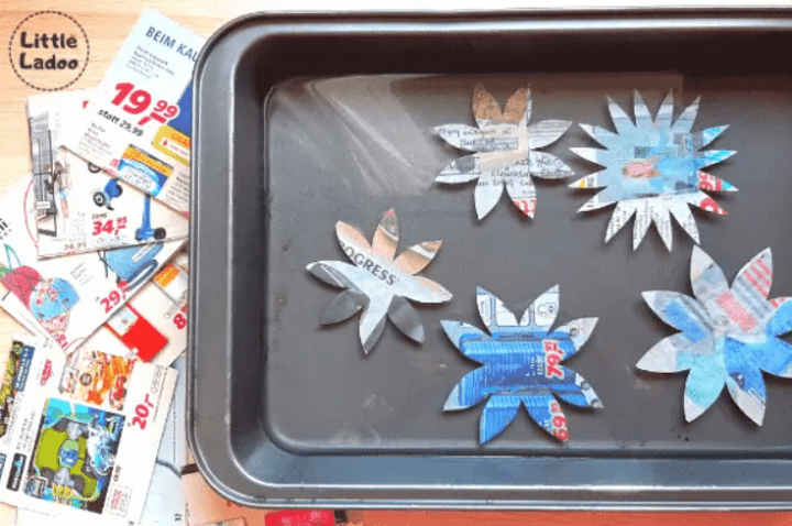 science experiments for kids shows five paper flowers on a tray.