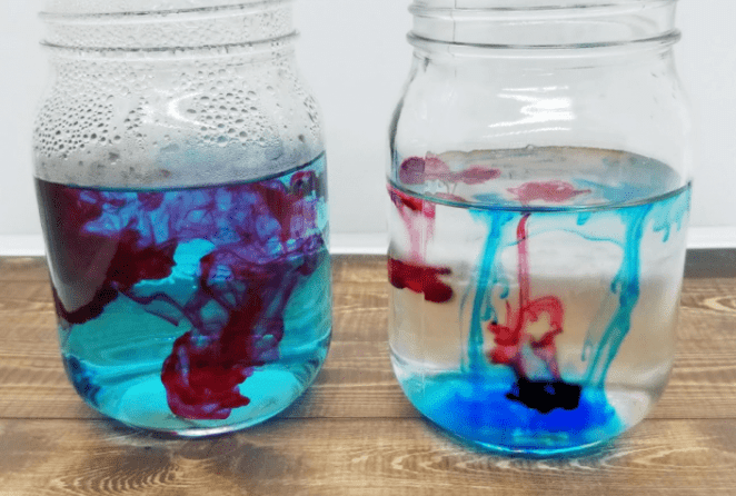 science experiments for kids shows two cups with liquid color flowing through.