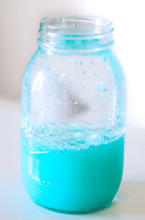 science experiments for kids shows a jar with blue liquid settled on the bottom.