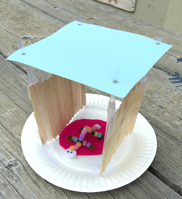 science for kids shows a popsicle stick house with a little bead critter inside.