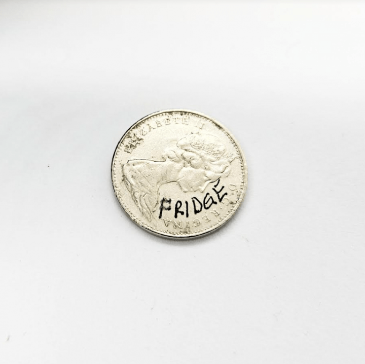 escape room for kids shows a nickel with the word fridge written on it.