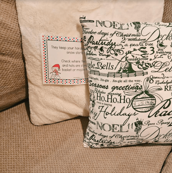 Best Christmas Scavenger hunt shows a clue between couch cushions.