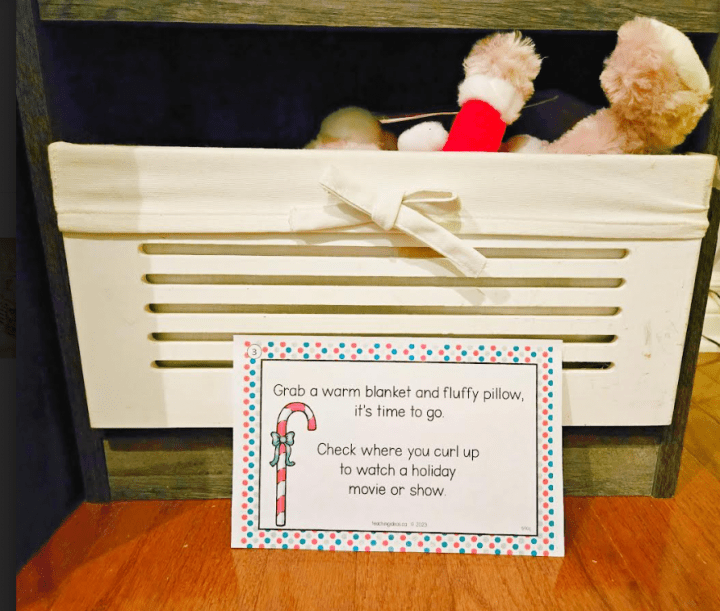 scavenger hunt for kids shows a clue in front of a toy box that tells players to check where you would watch a holiday movie.