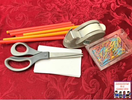 STEM activity shows materials needed for a STEM activity including straws, tape, scissors, paper and paper clips.