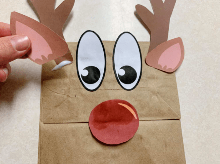 reindeer craft shows a reindeer made from a paper bag.