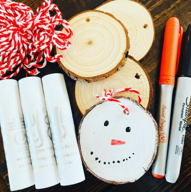 christmas ideas shows wood slices and a snowman painted on one.