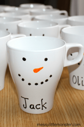 preschool christmas craft shows a mug painted to look like a snowman with the name Jack.