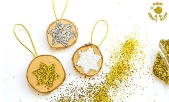 preschool christmas craft shows wood slice ornaments with stars on each.