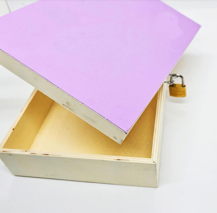 diy escape room shows a purple lock box but the lid tips off on the other side of the lock.
