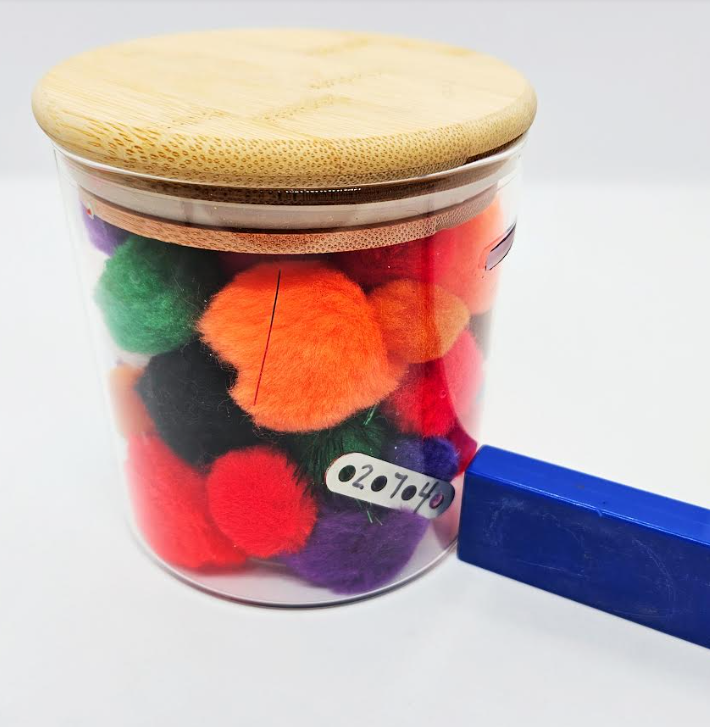 puzzles for kids shows a clear jar with pompoms and a magnet number on it.