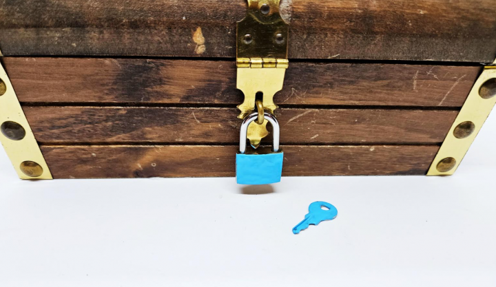 escape room ideas shows a locked box with a blue painted lock and blue key.