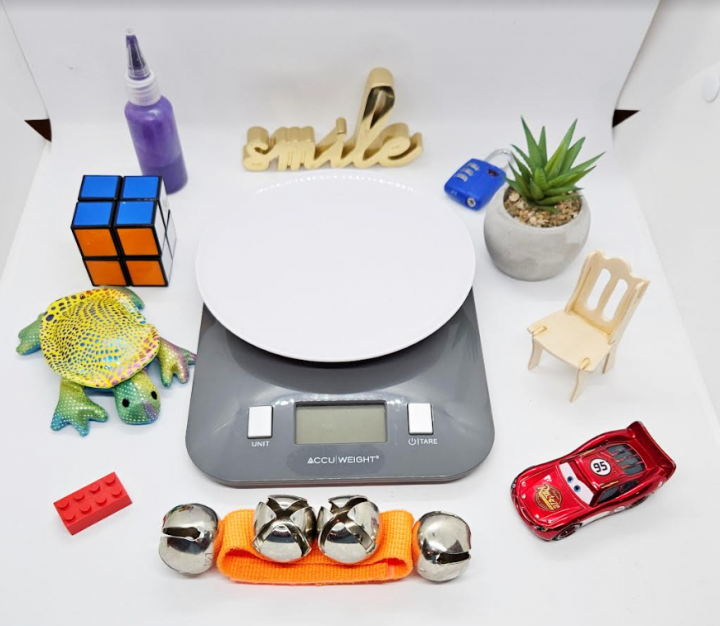 escape room ideas shows a scale and a collection of random objects around it.