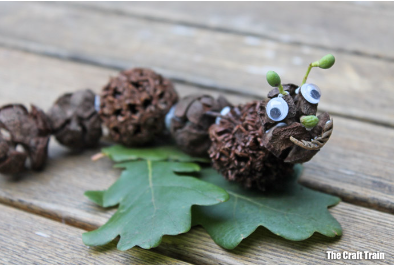 DIY nature craft shows a caterpillar looking critter made from things found in nature.