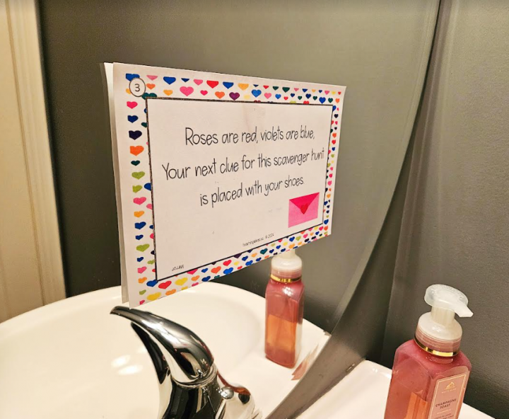 valentines day scavenger hunt shows a riddle taped to a mirror.