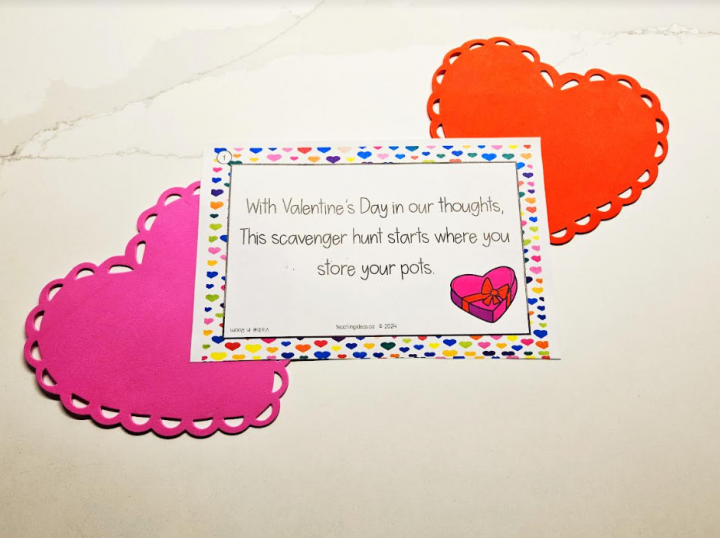 valentines day scavenger hunt shows a welcome letter set on two foam hearts.