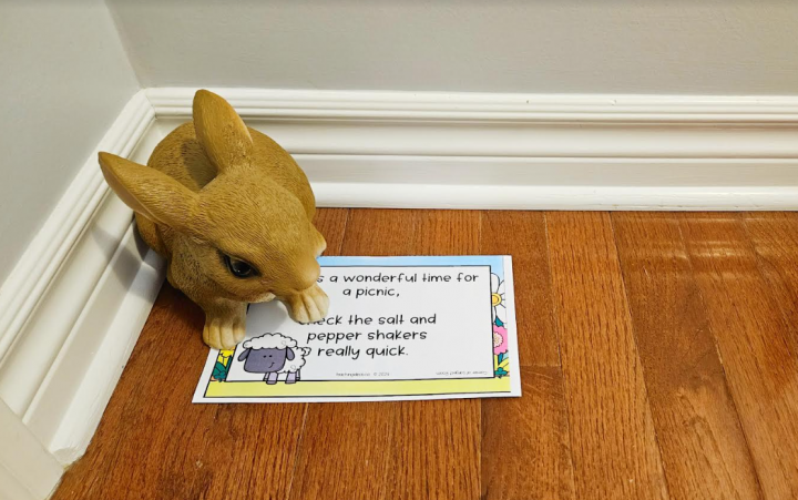 spring scavenger hunt shows a printed riddle in a corner with a clay rabbit on top.