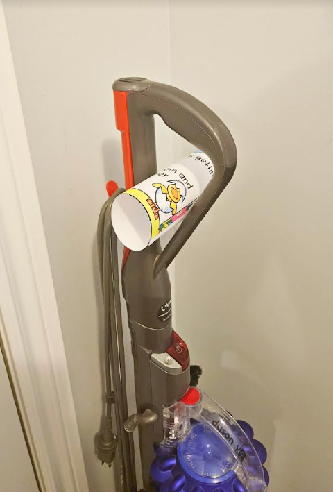 spring scavenger hunt shows a riddle rolled up and placed on a vacuum.