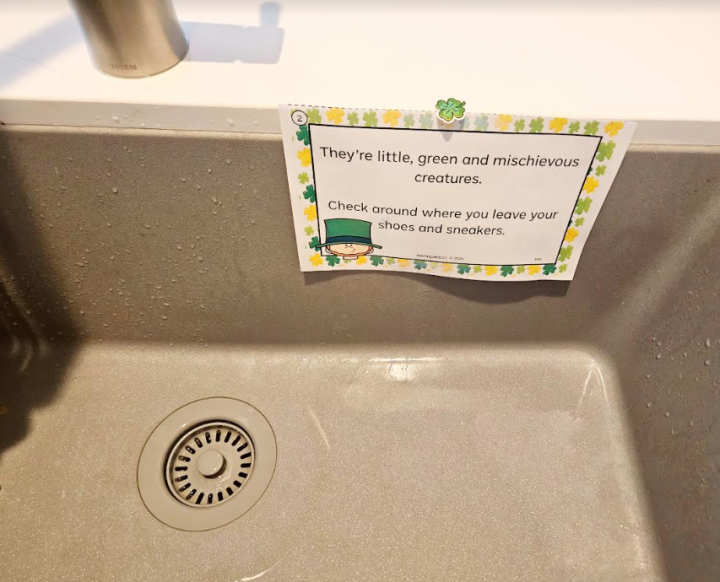 st patricks day scavenger hunt shows a riddle on a printed page on the edge of the sink.