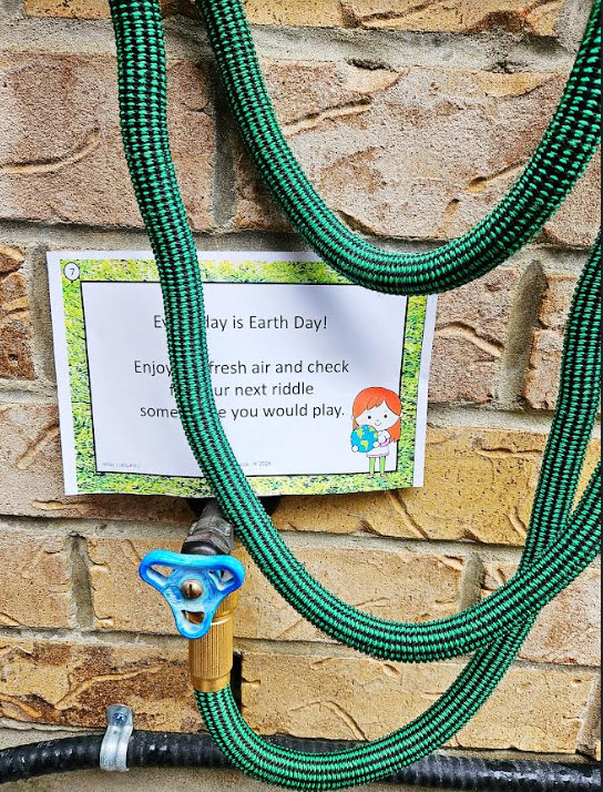 earth day scavenger hunt shows a riddle beside a hose.