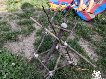 Summer Outdoor Learning Activities shows a catapult made from outdoor materials.