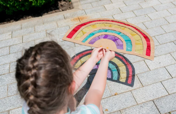 Summer Outdoor Learning Activities shows a child holding a rainbow sun catcher.
