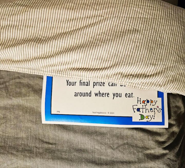fathers day activity printable shows a riddle on a bed comforter.