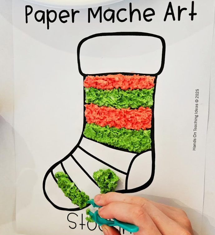 christmas stocking paper mache shows a printed stocking and paper mache pulp being put into the stripes on the stocking.