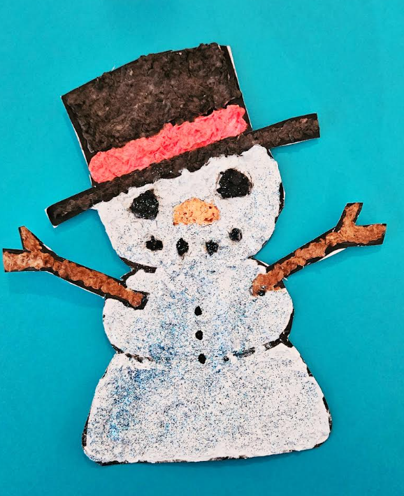 easy winter paper mache idea for kids shows a snowman on a blue background.