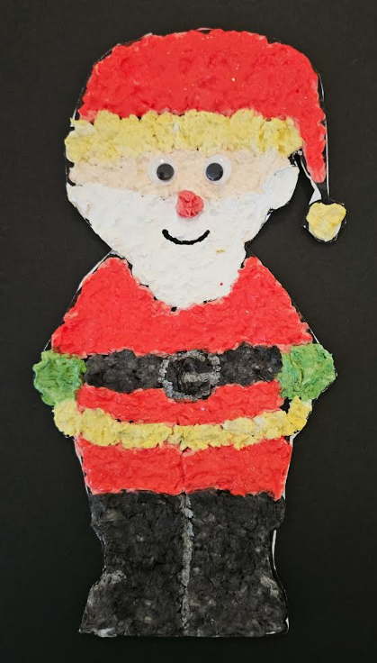 santa paper mache project for kids shows a paper mache Santa with a black background.