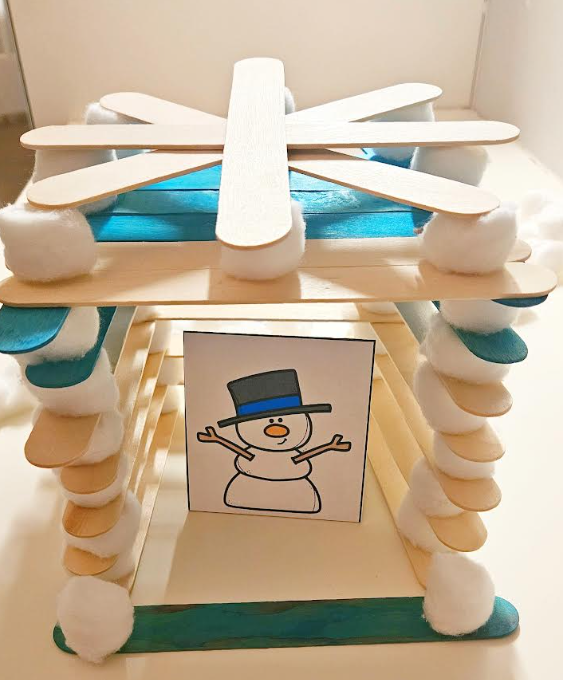 free winter stem activity shows a snowman image inside of a popsicle stick and cotton ball home.