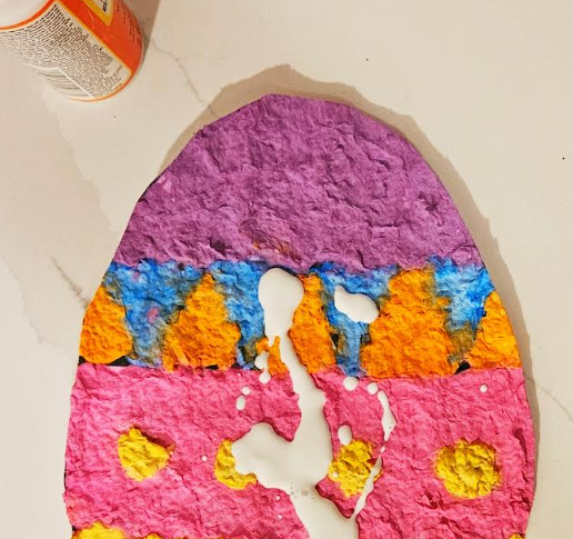 free Easter Paper Mache Project shows a paper mache egg with gloss glue on it.