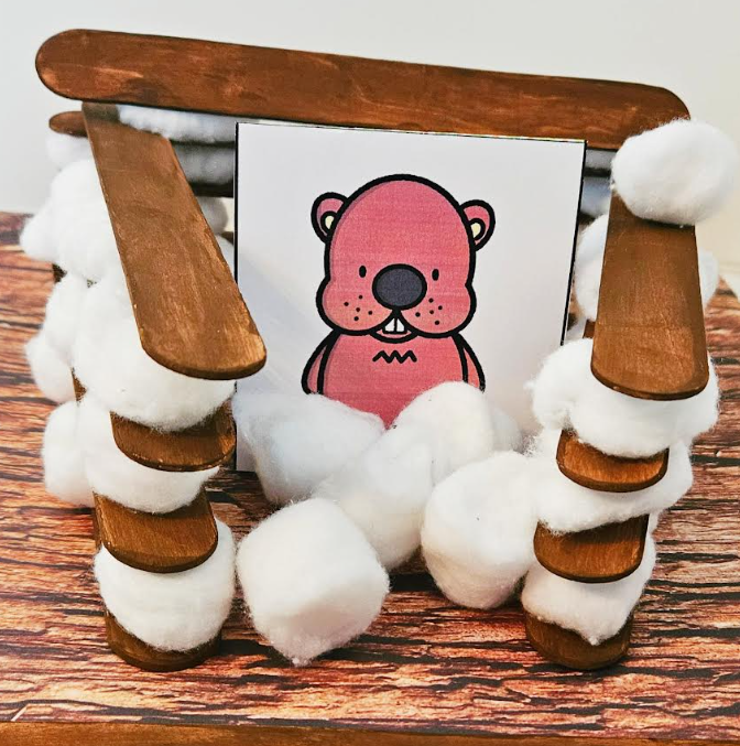 Groundhog day activity shows an image of a groundhog surrounded by a popsicle stick cotton ball structure.