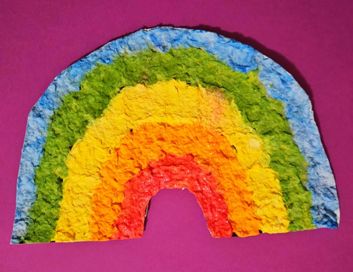 free rainbow paper mache art template shows a completed rainbow with a purple background.