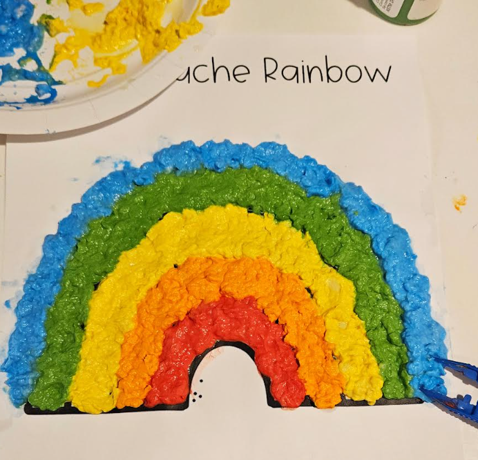messy art for kids shows a colorful rainbow made from paper.