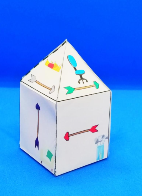 Valentines escape room for kids shows a printed paper clue that looks like a house and has arrows to follow printed on it.