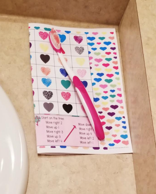 game for kids shows a printed page under a toothbrush.