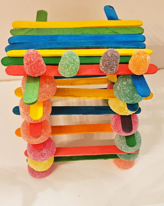 Candy activity shows a tower made from popsicle sticks and gumdrops.
