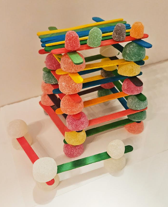 best candy STEM challenge shows a tower make from popsicle sticks and gumdrops.