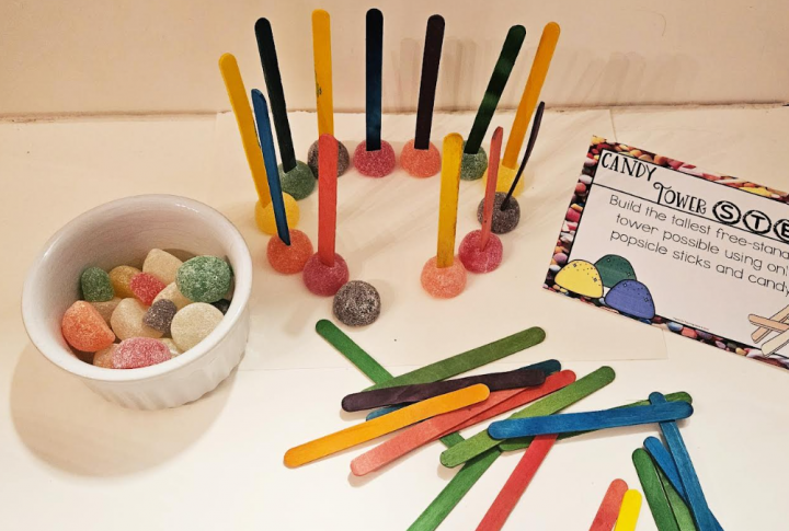 hands on building activity shows a structure made by sticking popsicle sticks into gumdrops.