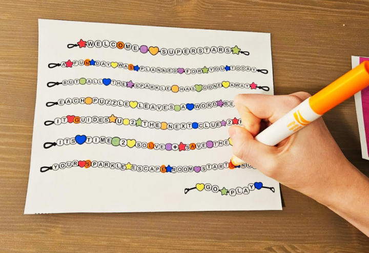 free escape room shows a child highlighting letters on a welcome letter to solve a puzzle.