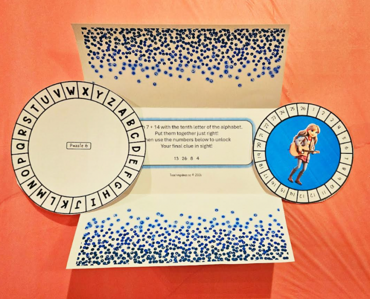 free printable escape room for tweens shows a folded sparkly page with two wheel cutouts beside the page.