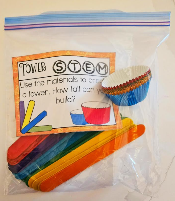 STEM kit shows a bag with a task card and cupcake liners and popsicle sticks.