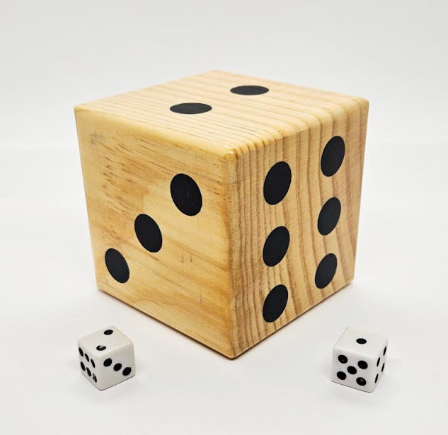 best math talks for kindergarten and preschool shows a large wooden die and two small dice.