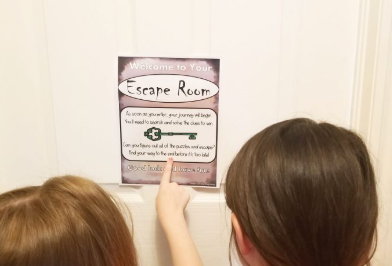 welcome letter shows two childing pointing at a printed letter taped to a door.